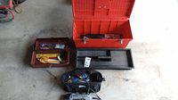 Overview of all tools including large red toolbox, small red toolbox, black toolbox tray insert, and Dremel Multi-Max tool with carrying bag