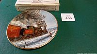 Front view of plate with original box and edition card