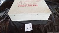 Closed white metal first aid kit showing branding and overall wear