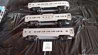 Three silver Lionel passenger cars side-by-side showing overall condition