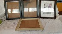 Front view of four wood photo frames showing colours and glass