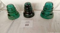 Three Hemingray glass insulators front view