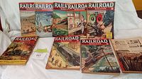 Seven Railroad Magazine covers and additional copies in front row