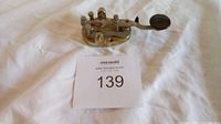 Top view of brass Morse key with lot card 139