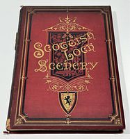 Front cover of the antique book titled 'Scottish Loch Scenery' with red cloth binding and gilt title lettering accented with decorative element showing some wear around edges.