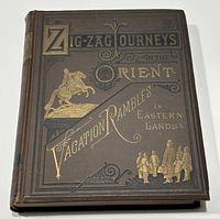 Front cover of the book, showing the title 'Zigzag Journeys in the Orient Vacation Rambles in Eastern Lands' with gilt and black decoration on brown cloth.