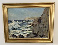 Full view of framed painting showing seascape with rocky cliff and waves