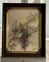 Full view of the framed watercolour painting showing the grapevine and leaves with the dark wooden frame and gold accents.
