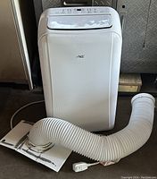 Front view of white portable AC unit with attached flexible exhaust hose and window vent adapter