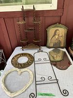 Overview of various decorative frames, wall racks, and a 3-tier wooden display stand, showing arrangement on table