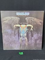 Front cover of Eagles 'One of These Nights' vinyl LP showing winged skull artwork.