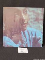 Front view of the Sade - Promise vinyl LP album cover showing the face of a woman and the album title