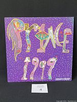 Front cover of the Prince 1999 double vinyl LP with colorful stylized lettering on purple background