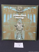 Front cover of Edward Bear Bearings album showing stylized figure in an empty subway car interior with album and band name.