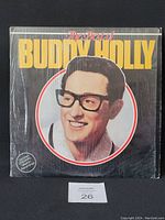 Front cover of The Best of Buddy Holly vinyl LP album in shrink wrap, showing the title and portrait of Buddy Holly.