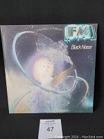 Front cover of the vinyl LP titled 'Black Noise' by IFM, showing abstract sci-fi artwork with a face and a circular design.