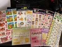 Pack assortment showing various sticker packs including Rilakkuma, Pokemon, Tokidoki, and more.