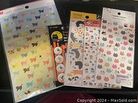 Photo showing six packs of stickers featuring dogs, cats, and various animals on colorful backgrounds