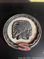 Full view of the circular Jeep Cherokee Chief emblem showing the Native American chief profile with feather headdress and the red 'S' at the bottom.