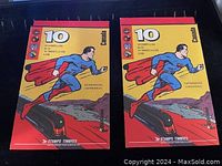 Two identical vintage Canadian stamp booklets featuring a superhero in blue and red costume with cape on front cover.