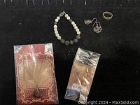 Overview of sterling silver jewelry including bracelet with beads, two sets of earrings, and Mexico Alpaca ring with mother of pearl inlay and damage to band