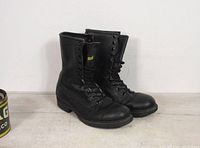 Side angle of both black combat boots showing laces and shape