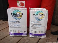 Front view of two boxed Polyblend non-sanded tile grout containers, showing branding, weight (10 lbs / 4.5 kg), and product details.