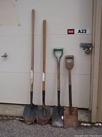 Front view of all four garden shovels including 2 long-handle round-point spades and 2 short-handle square mouth shovels with D-grips, showing condition and overall appearance.