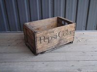 Side view of vintage Pepsi Cola wooden crate showing branding "Refreshing Pepsi-Cola Satisfaction".