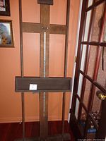 Full front view of the wooden adjustable easel with tray and central vertical support.