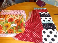 Nine cut-out apron front pieces in various polka dot and star prints displayed on table