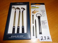 Set of three golf club-shaped pens in black and gold-tone, packaged in black box.