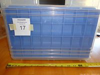 Front view showing the large size and clear plastic body of the tote with blue side latches.