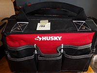 Front view of Husky tool bag showing brand name and multiple pockets.