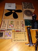 Wood mounted rubber stamps of various designs and two green ink pads, black stamp spot.