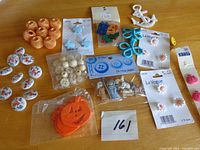 Overview of multiple button sets including oriental motif china buttons, nativity button set, pumpkin-shaped buttons, white round buttons, butterfly and flower shaped buttons, and gold textured buttons.