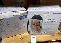 Two boxes of YourFacePillow Anti-Aging Beauty Pillows shown, one with torn packaging.