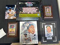 Full view of memorabilia lot including framed Phillies team photo plaque, signed artwork, player photo plaques including Chase Utley and Ryan Howard.