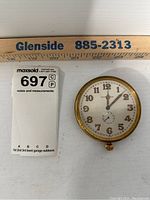 Top view of Longines oversized pocket watch showing the dial, brand name, Arabic numerals, gold-tone hands, and small seconds subdial.