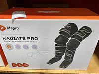 Box front showing Lifepro Radiate Pro whole leg massager with heat, image of product on box, brand logo, product name and features.