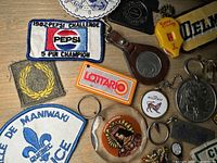 Close-up view showing patches including '1982 Pepsi Challenge 5 Pin Champion', and keychains including Lottario and Scout Cookie