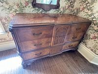 Front and right side view of Victorian dresser showing top surface with slight water damage and six drawers with inlaid marquetry.