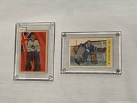 Two cards side by side in clear screw-down holders, front view