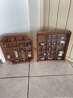 Both wooden wall mount display cases, octagon and square shapes, showing compartments and miniatures inside