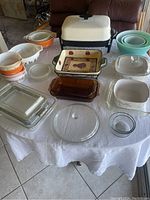 Overall view of lot on table showing bowls, baking dishes and electric skillet