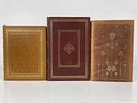 Front view of three leather bound Franklin Library first edition books arranged upright