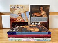 Photo of 8 Sotheby's and Christie's catalogues featuring Spanish paintings with visible cover art showing classic and contemporary artworks.