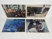 Four lobby cards featuring scenes from the movie including apes and humans interacting, police officers, and action scenes.