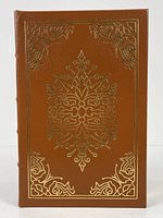 Front cover of the book showing full brown leather binding with gold embossed detailing.