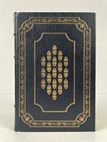 Front cover of the book showing embossed gold design on dark leather.